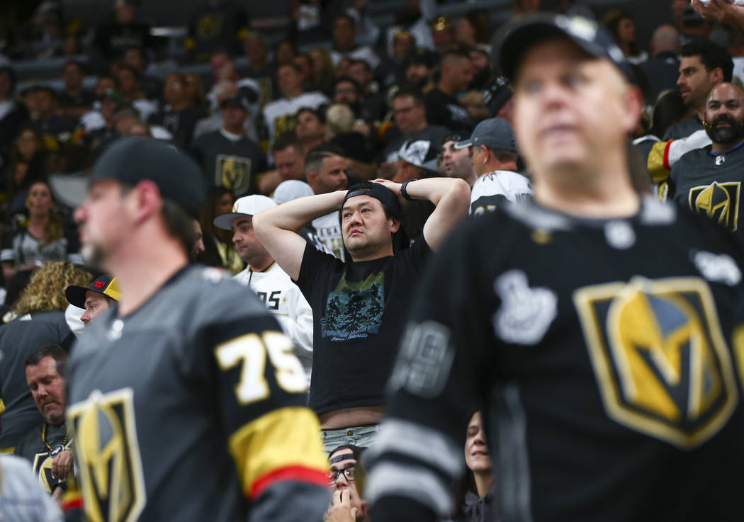 Golden Knights fans react after losing to the San Jose Sharks in a double overtime period in Ga ...