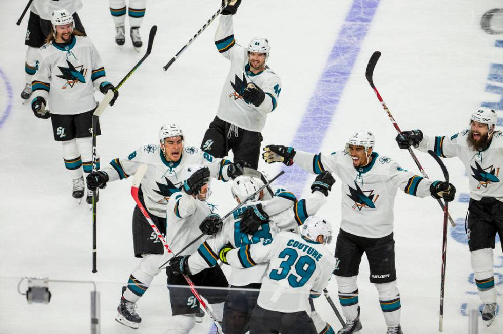 San Jose Sharks center Tomas Hertl (48) is mobbed by teammates after scoring the winning goal d ...