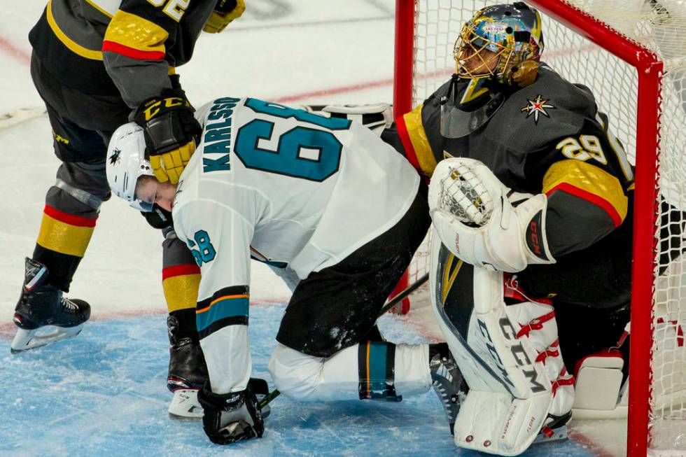 San Jose Sharks center Melker Karlsson (68) is pushed away by Golden Knights goaltender Marc-An ...