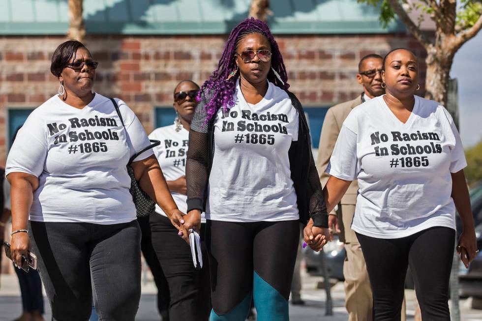 Consuela Nicole, left, Akiko Cooks and Jshauntae Marshall walk hand-in-hand outside the Clark C ...