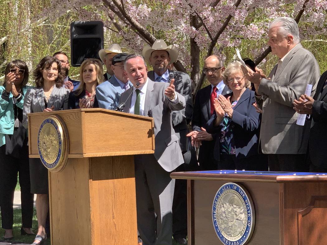 State Sen. Chris Brooks, D-Las Vegas, speaks at the signing Senate Bill 358, committing the sta ...