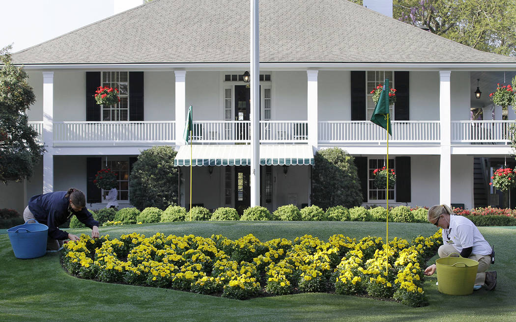 Michelle Stevens, left, and Anna Yeager manicure the flower bed in front of the clubhouse at th ...