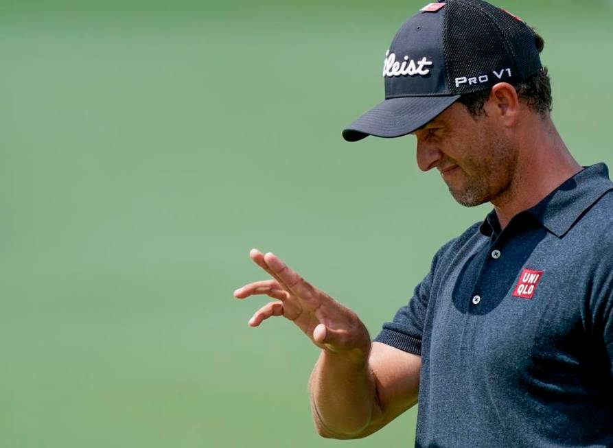 Adam Scott, of Australia, lines up a putt during the third round for the Masters golf tournamen ...