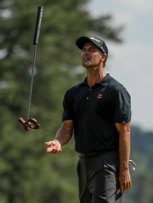 Adam Scott, of Australia, reacts to a putt on the eighth hole during the third round for the Ma ...