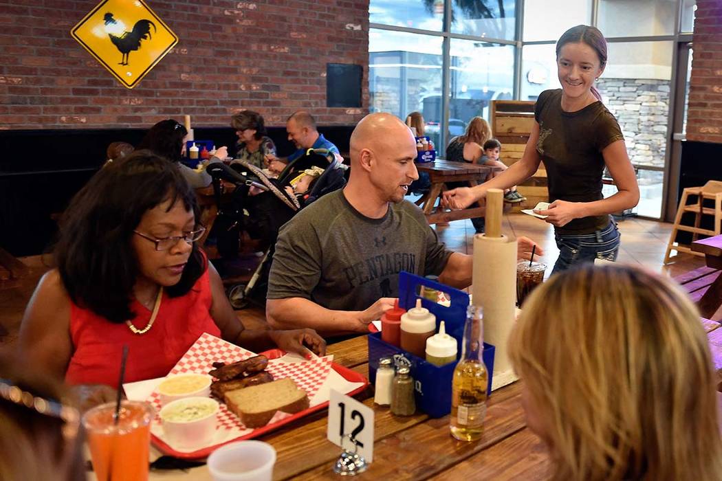 Owner Natalia Badzjo, right, checks on her customers at Big B's Texas BBQ in Henderson. (David ...