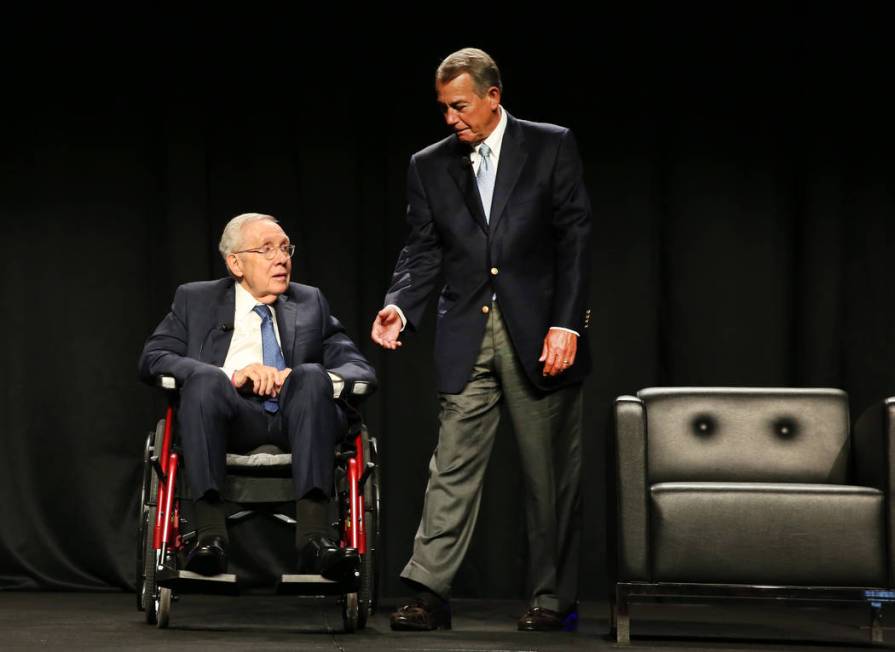 Former Speaker of the House John Boehner, right, extends his arm to shake hands with former U.S ...