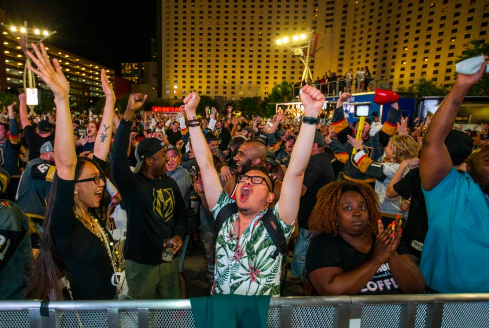 Golden Knights fans Malia Tibbie and Carlos Benito celebrate with others as the Knights tie San ...