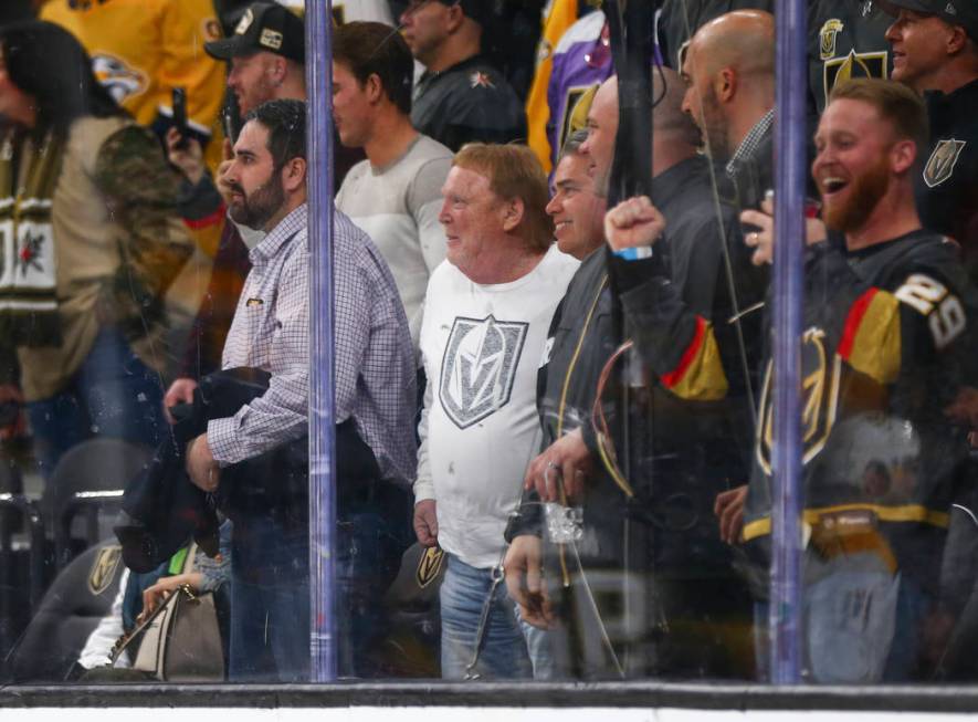 Oakland Raiders owner Mark Davis, center in white, attends an NHL hockey game between the Golde ...