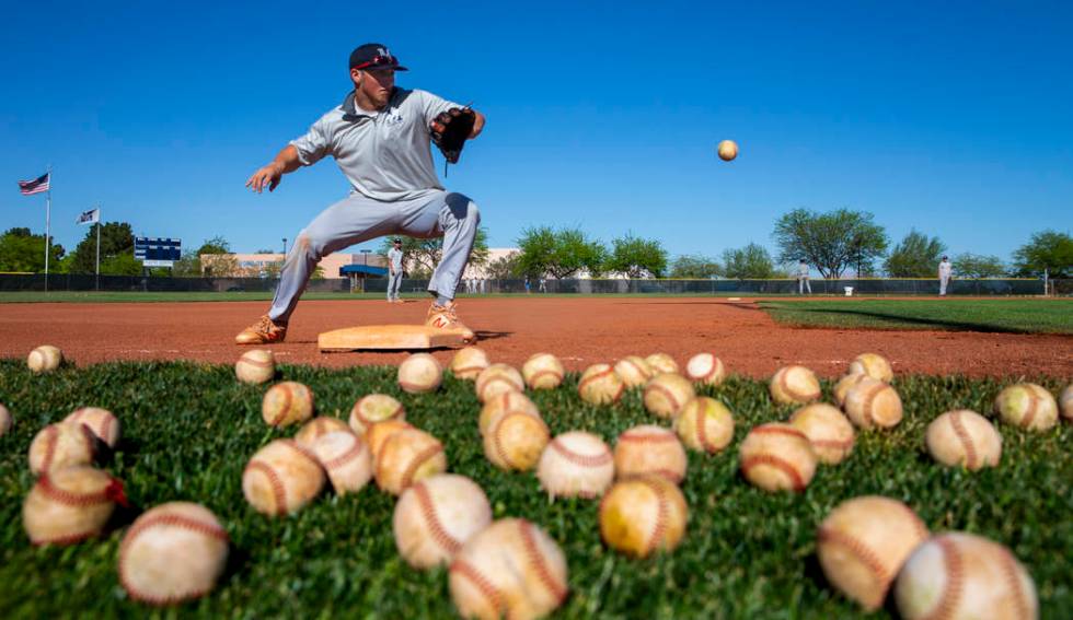 The Meadows School third baseman Sam Kaplan looks in a high ground ball during fielding practi ...