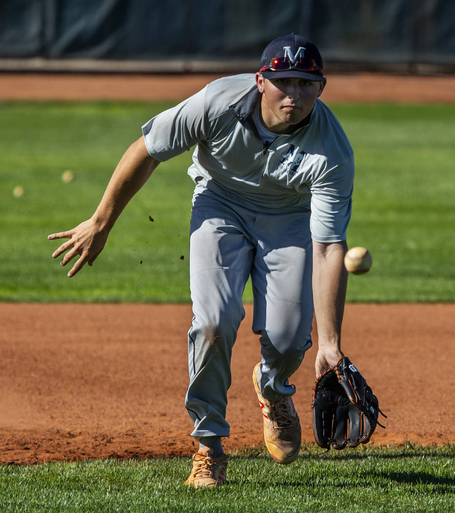 The Meadows School third baseman Sam Kaplan eyes a high bouncer during fielding practice, he wi ...