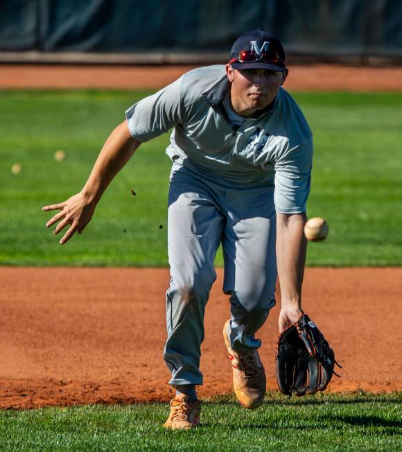 The Meadows School third baseman Sam Kaplan eyes a high bouncer during fielding practice, he wi ...