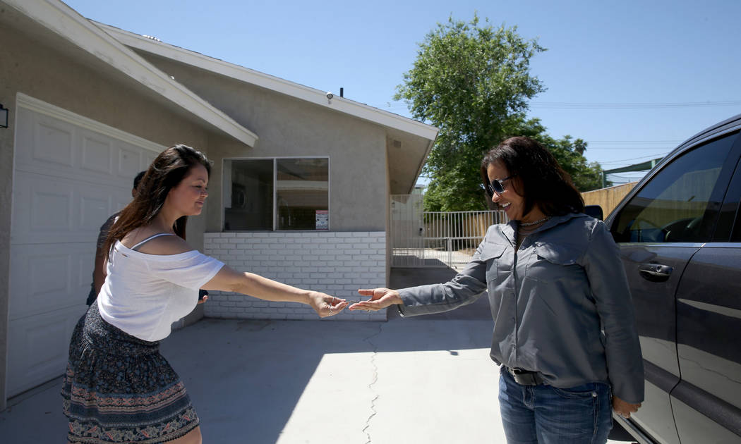 Ana Martinez, a veteran who was homeless two years ago, gets the key to her Las Vegas home from ...