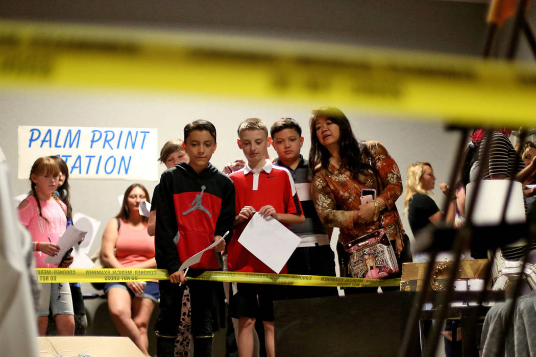 Isaiah Cordova, 12, from left, Alex Holliday, 11, Jordan Noble, 13, and his mom Suzan Noble exa ...