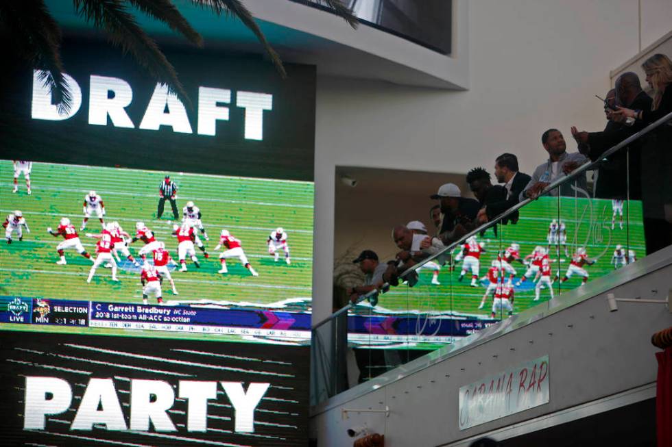 Crowds watch and mingle during a Raiders draft party at Drai's nightclub at The Cromwell hotel- ...