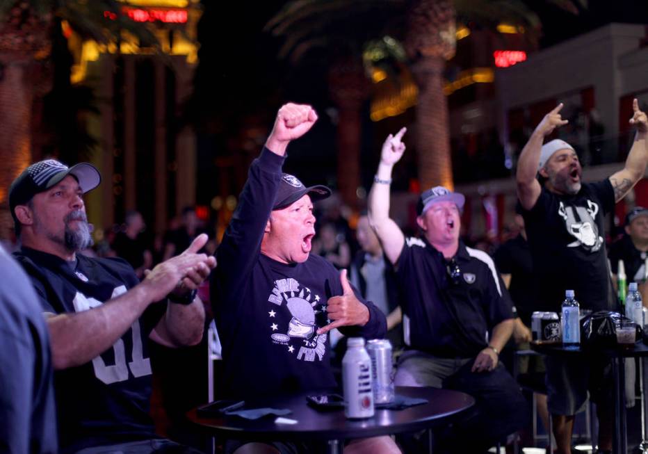 Josh Sprinkle, from left, and Sean Bogguess, both of Los Angeles, react to the 27th draft pick ...