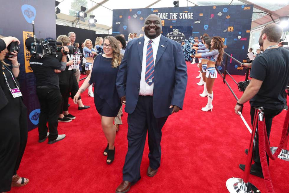 Gregory Hampton, winner of the NFL 100 season ticket giveaway, walks the NFL draft red carpet, ...