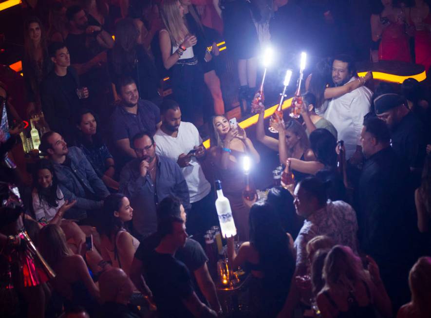 Bottles of alcohol are delivered to a table in the nightclub area during the grand opening week ...