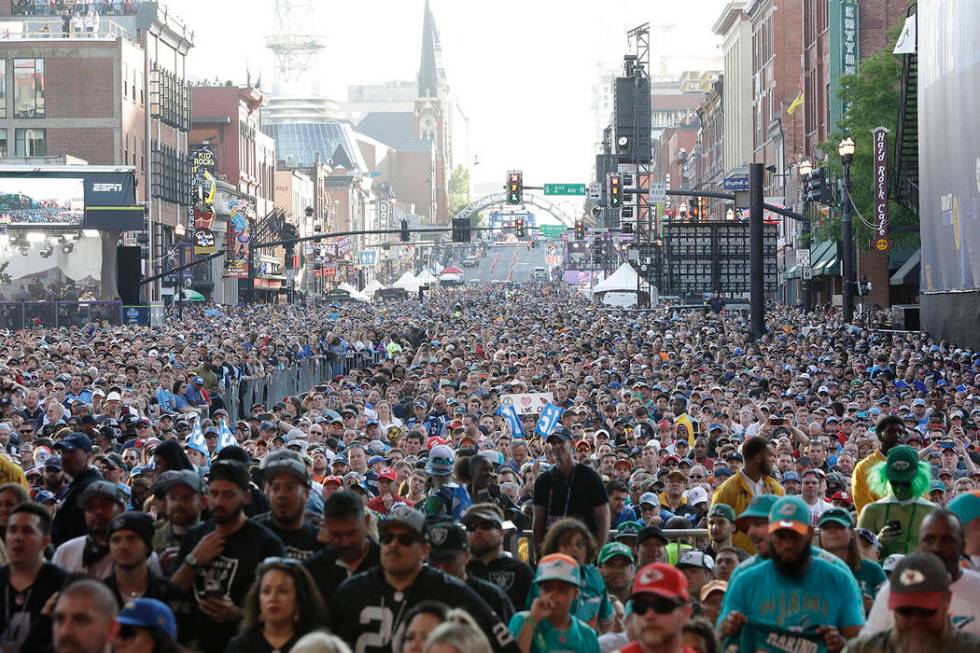 Fans stand near the main stage ahead of the second round of the NFL football draft, Friday, Apr ...