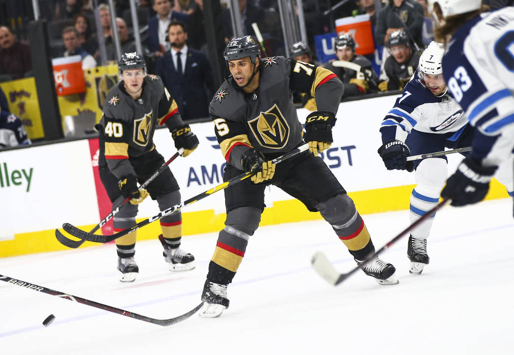 Golden Knights right wing Ryan Reaves (75) passes the puck under pressure from Winnipeg Jets de ...