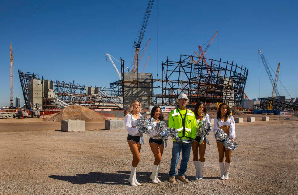 Labor concrete foreman Dave Durbin is flanked by the Raiderettes as he helps the Raiders announ ...