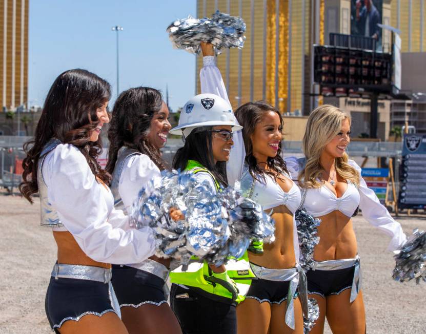 Day laborer Amale Garcia is flanked by the Raiderettes as she helps the Raiders announce their ...