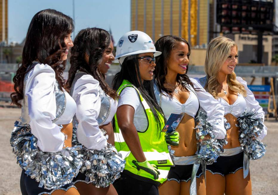 Day laborer Amale Garcia is flanked by the Raiderettes as she helps the Raiders announce their ...