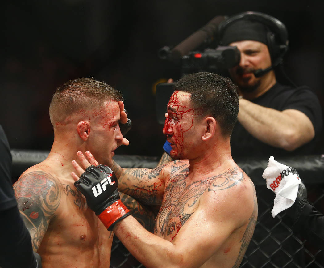 Max Holloway, right, and Dustin Poirier acknowledge one another during an interim lightweight t ...