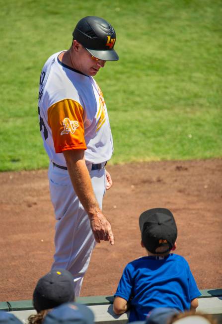 Aviators manager Fran Riordan (39) instructs a young fan to careful and stay off the field afte ...