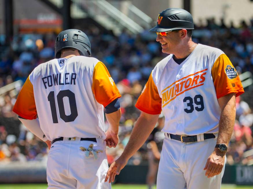 Base runner Skye Bolt (8) is congratulated by Aviators manager Fran Riordan (39) as he makes it ...