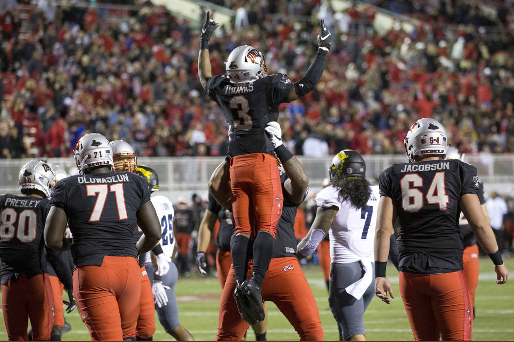 UNLV Rebels running back Lexington Thomas (3) celebrates with teammates after scoring a touchdo ...