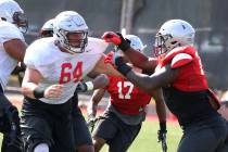 UNLV's defensive end Jameer Outsey, right, defends offensive lineman Nathan Jacobson (64) durin ...