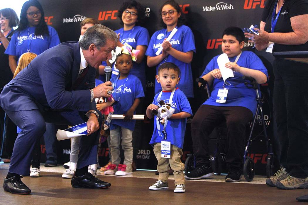 Bruce Buffer, the official announcer for UFC events, tells Jon Ryan Maguiat, 4, on Monday, Apri ...