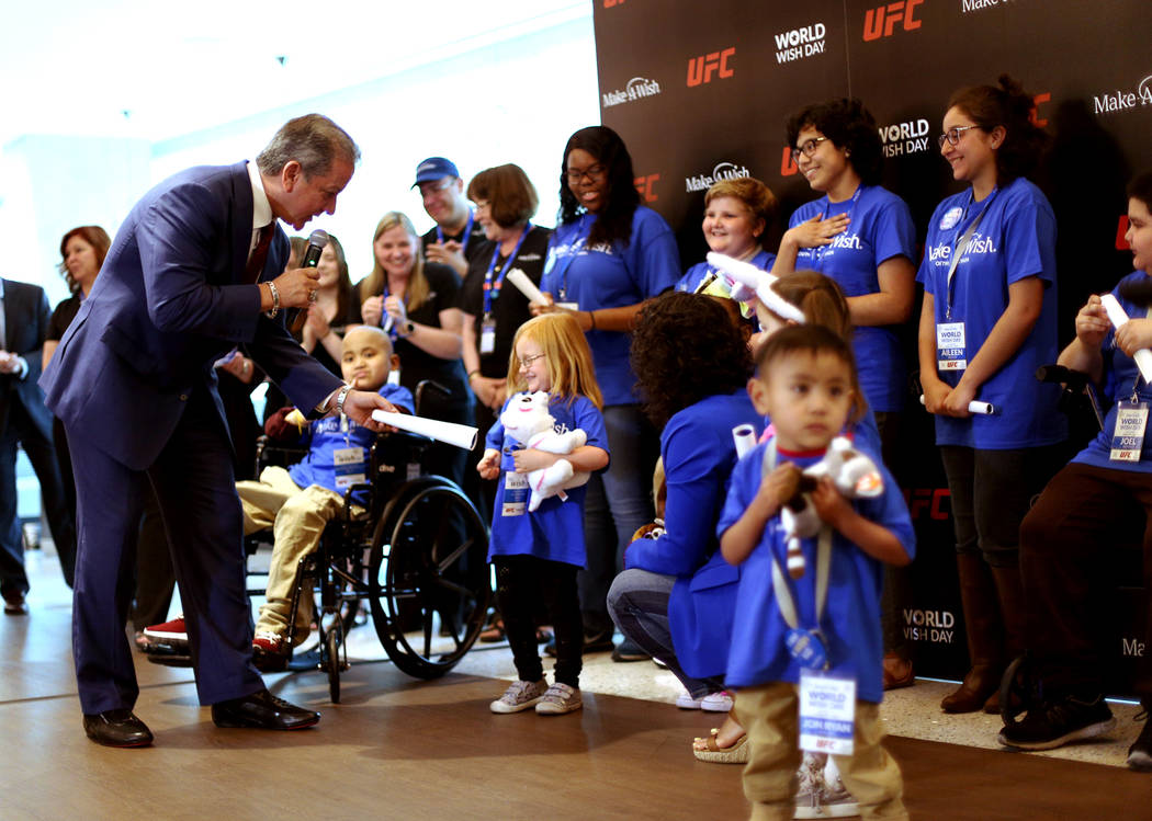 Bruce Buffer, the official announcer for UFC events, tells Emma Dangler, 6, that her wish to go ...