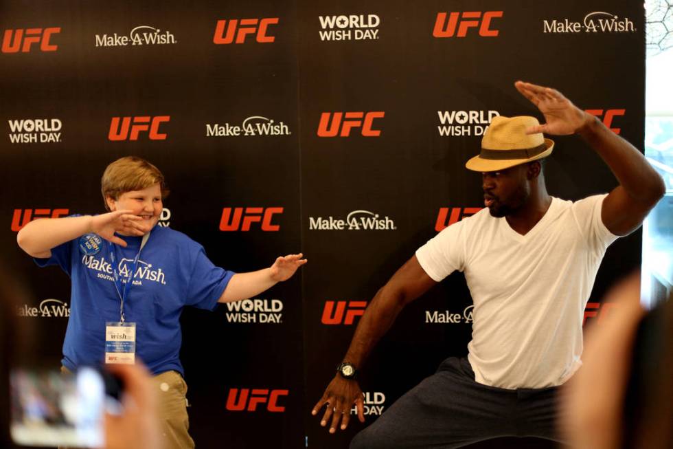 Elijah Barile, 11, poses with UFC fighter Uriah Hall at an event by Make-A-Wish in partnership ...