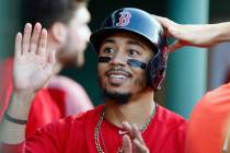 In this Friday, July 13, 2018 file photo,Boston Red Sox's Mookie Betts celebrates after scoring ...