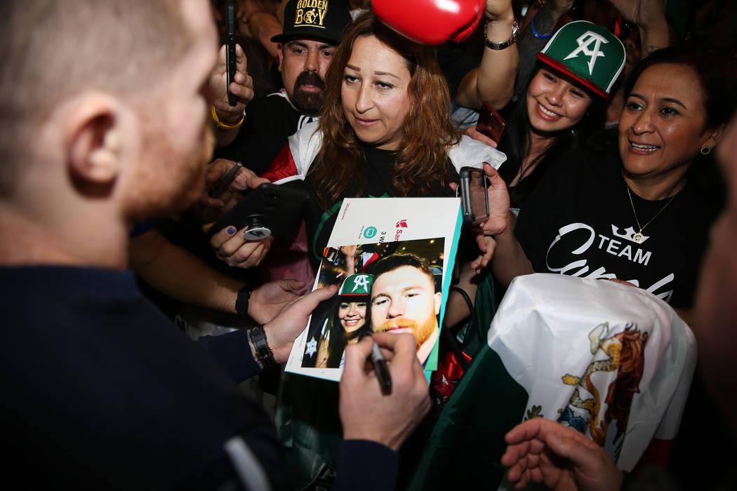 Saul "Canelo" Alvarez signs an autograph during his grand arrival at MGM Grand hotel- ...
