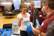Bea Aikens, center, gives directions during a National Problem Gambling Awareness Month event a ...