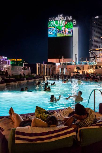 Pool goers enjoy a showing of Happy Gilmore during Dive in Movies at Boulevard Pool on Monday, ...