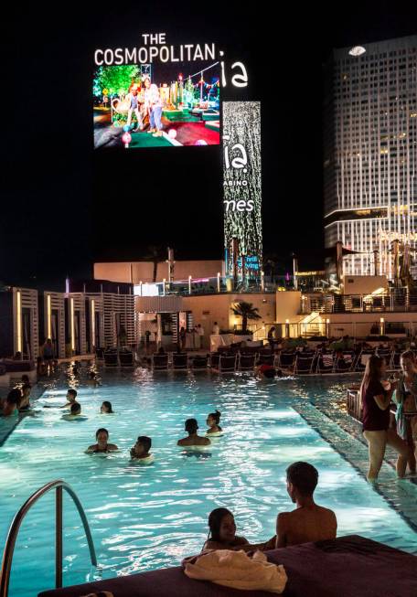 Pool goers enjoy a showing of Happy Gilmore during Dive in Movies at Boulevard Pool on Monday, ...