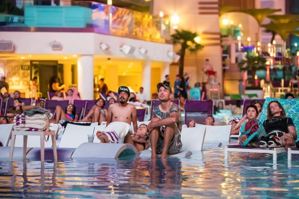 Pool goers enjoy a showing of Happy Gilmore during Dive in Movies at Boulevard Pool on Monday, ...