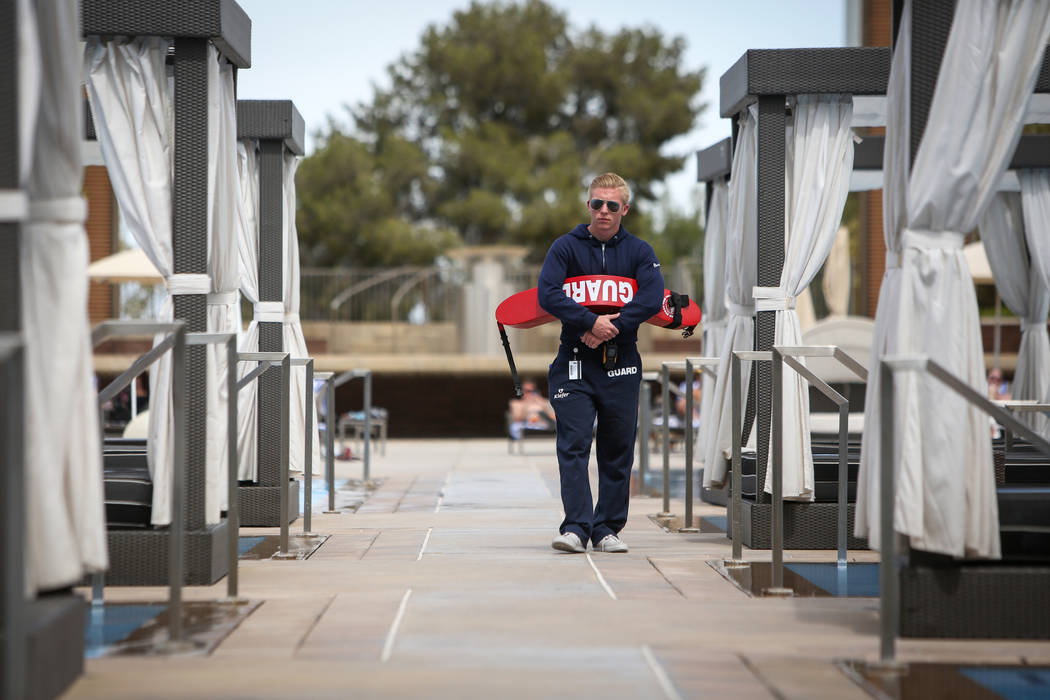Lifeguard Vance Ferron walks out by the pool at the M Resort in Henderson, Thursday, April 4, 2 ...