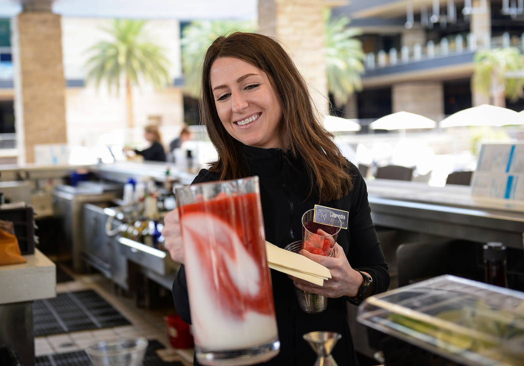 Bartender Cassie Leith makes a drink at the pool bar at the M Resort in Henderson, Thursday, Ap ...