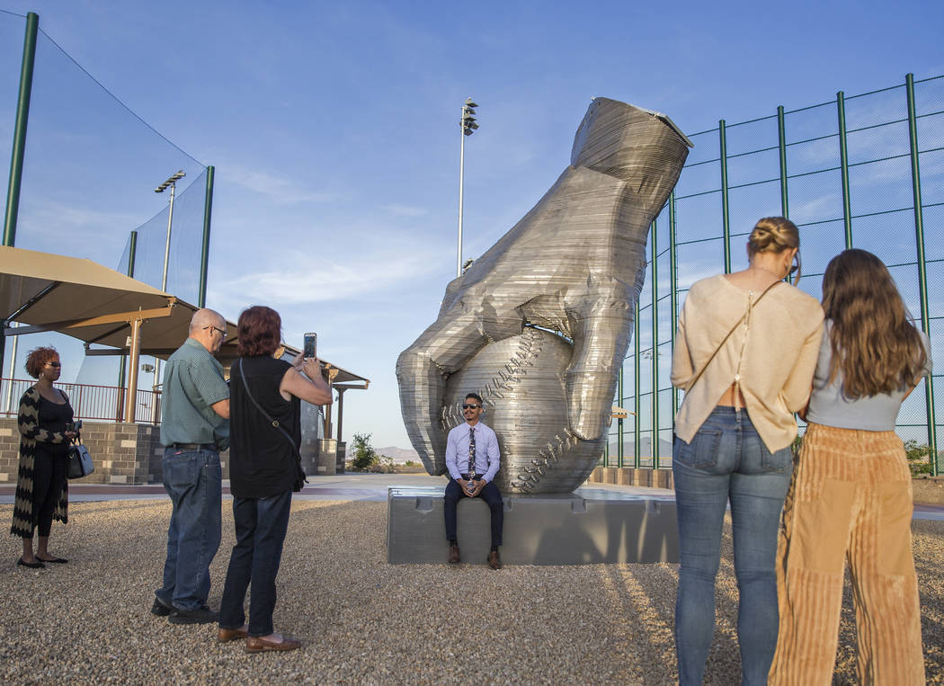 Artist Luis Varela-Rico, back/middle, sits with his sculpture "Organic Study No. 2" d ...