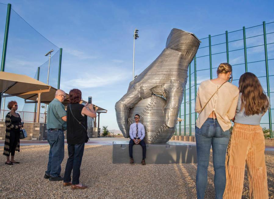 Artist Luis Varela-Rico, back/middle, sits with his sculpture "Organic Study No. 2" d ...