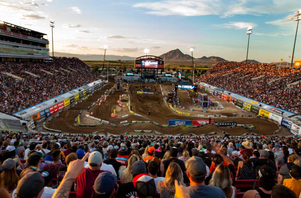 Motorcycles blur by during the featured 450 SX class race at Sam Boyd Stadium on Saturday, May ...