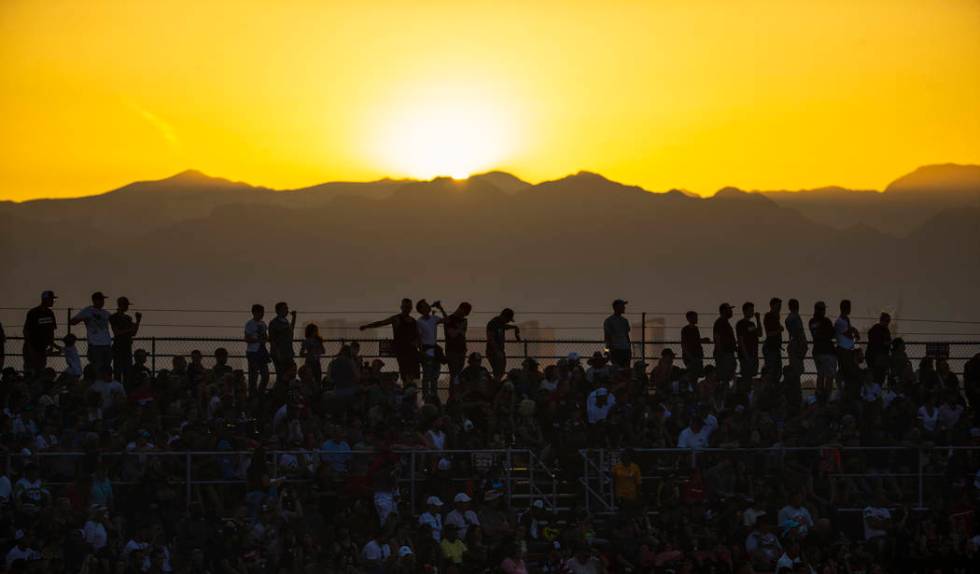 The sun sets behind fans during the featured 450 SX class race at Sam Boyd Stadium on Saturday, ...