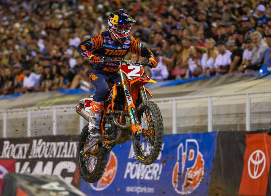 Red plate points leader Cooper Webb (2) takes a big jump as he leads the pack during the featur ...