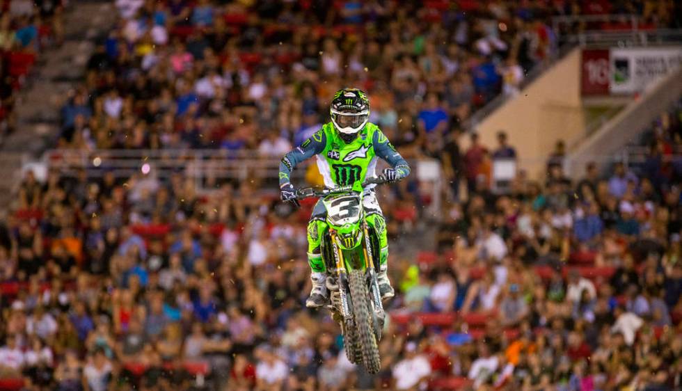 Eventual race winner Eli Tomac (3) soars above the track during the featured 450 SX class final ...