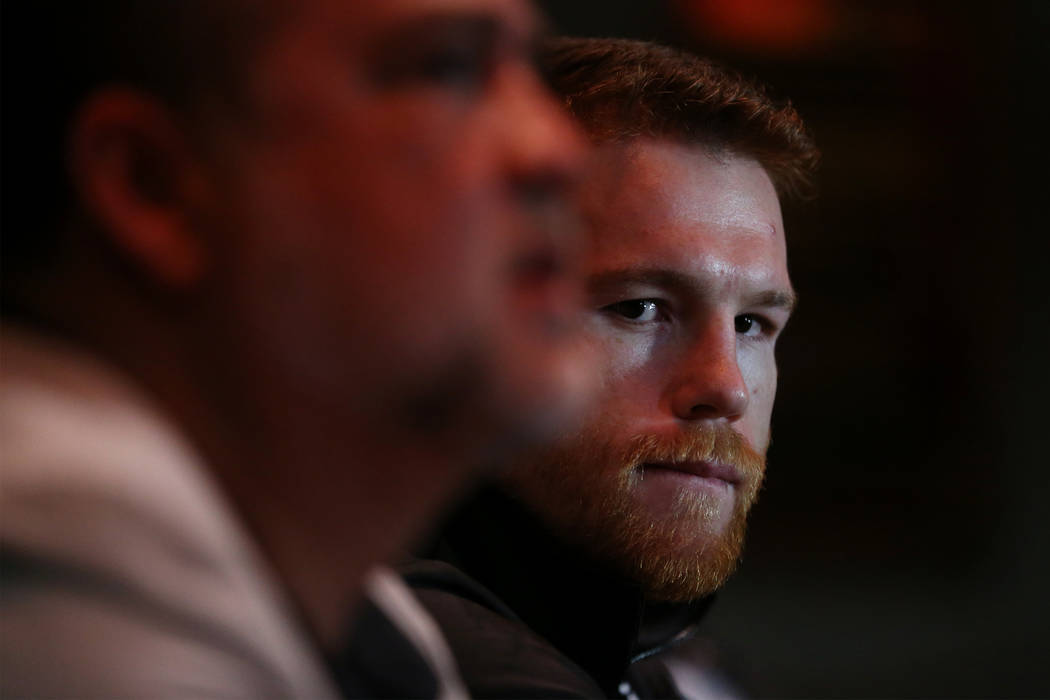 Saul "Canelo" Alvarez, right, speaks to reporters during a press conference at the MG ...