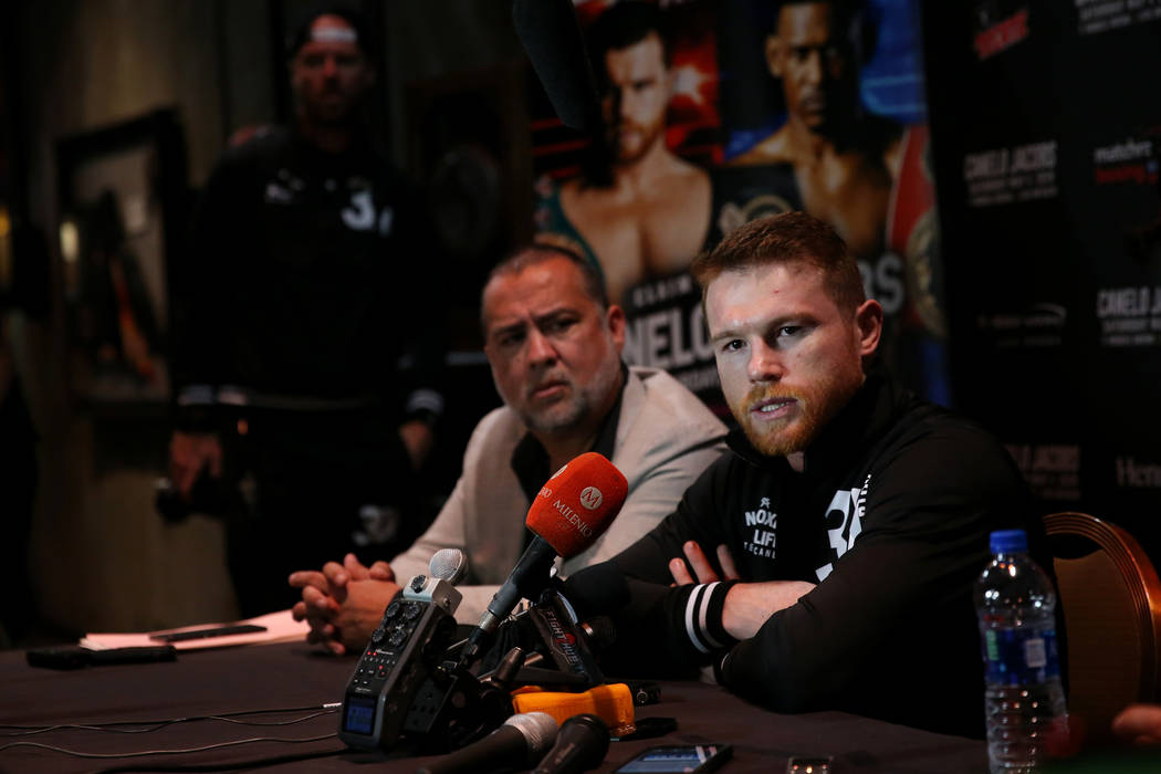 Saul "Canelo" Alvarez, right, speaks to reporters during a press conference at the MG ...